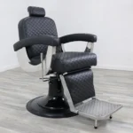 belmont barbers chair Knight barber chair featuring black vinyl with a diamond-stitched pattern, mirrored chrome metal armrests, and a heavy-duty hydraulic base.