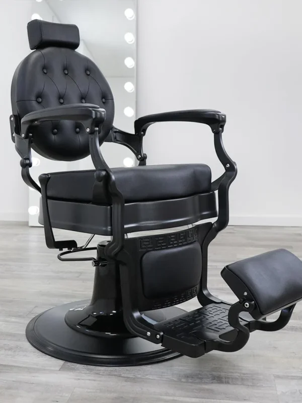 barber chair for sale Blackout barber chair in matte black vinyl with a tufted backrest, black powder-coated hydraulic base, and reclining handle.