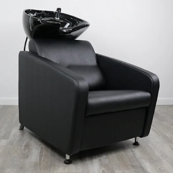 salon chair and shampoo bowl Gravity shampoo backwash unit featuring a sleek matte black fiberglass base, high-density black vinyl chair, and an adjustable tilting black ceramic bowl.