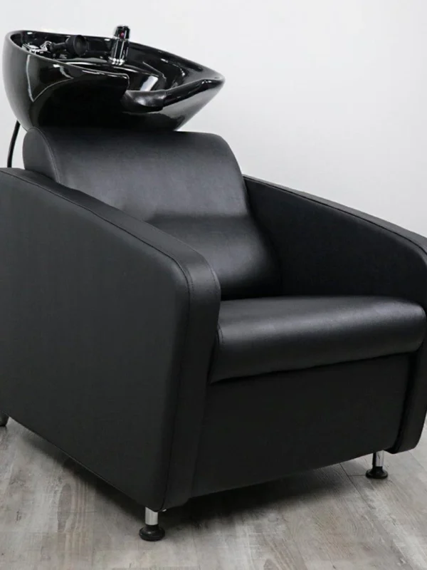 salon chair and shampoo bowl Gravity shampoo backwash unit featuring a sleek matte black fiberglass base, high-density black vinyl chair, and an adjustable tilting black ceramic bowl.
