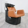 salon shampoo bowl chair Modern Illusion shampoo backwash unit featuring a sleek matte black fiberglass base, high-density black vinyl upholstery, and a deep tilting ceramic bowl.