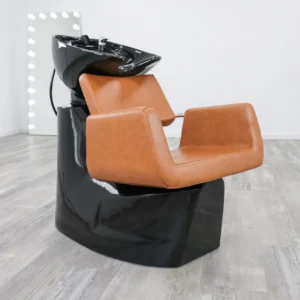 salon shampoo bowl chair Modern Illusion shampoo backwash unit featuring a sleek matte black fiberglass base, high-density black vinyl upholstery, and a deep tilting ceramic bowl.