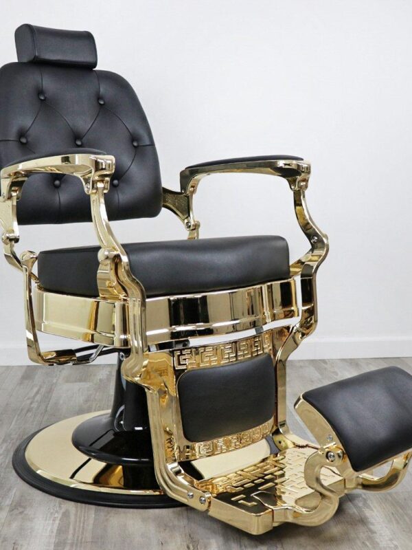 barber shop chairs Knockout Gold barber chair featuring matte black vinyl upholstery, a gold-chromed steel frame, tufted backrest buttons, and a heavy-duty hydraulic base.