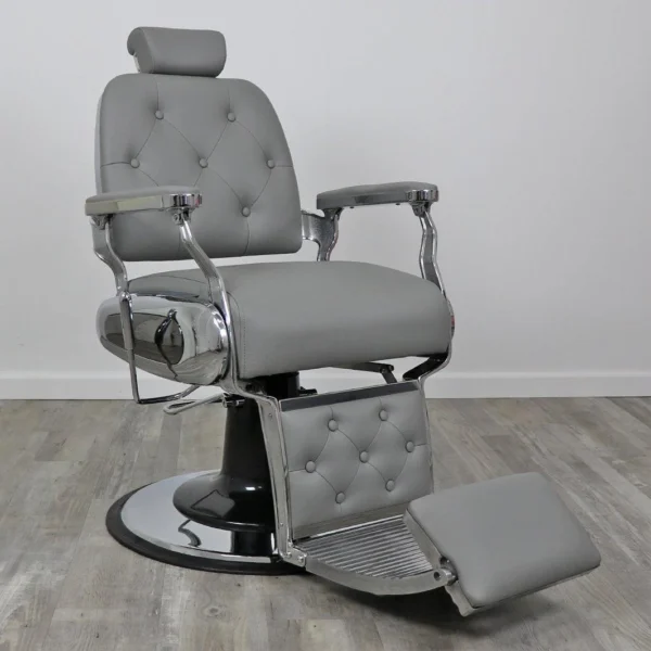 koken barber chairs Professional Supreme barber chair featuring a classic tufted backrest, reinforced chrome armrests, and a high-capacity hydraulic base for grooming.