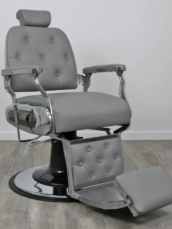 koken barber chairs Professional Supreme barber chair featuring a classic tufted backrest, reinforced chrome armrests, and a high-capacity hydraulic base for grooming.
