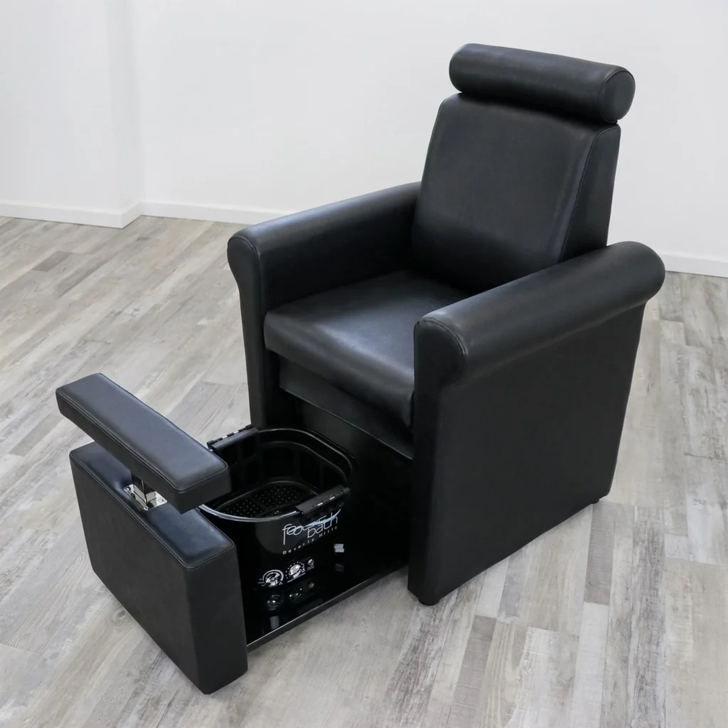 A luxurious, high-end pedicure chair with a sleek, modern design. The chair is made of plush, soft leather in a rich, burgundy color, accented with polished chrome details. It features an integrated foot bath with massaging jets and a temperature control system, creating a soothing and relaxing experience. The chair is positioned in a well-lit, spacious room with large windows, allowing natural light to flood the space. The flooring is a smooth, polished marble in a neutral tone, complementing the chair's elegant aesthetic. The overall atmosphere evokes a sense of tranquility and indulgence, perfect for a pampering pedicure session. The chair bears the "James Barber Shop" branding, indicating its high-quality craftsmanship and attention to detail. Prompt