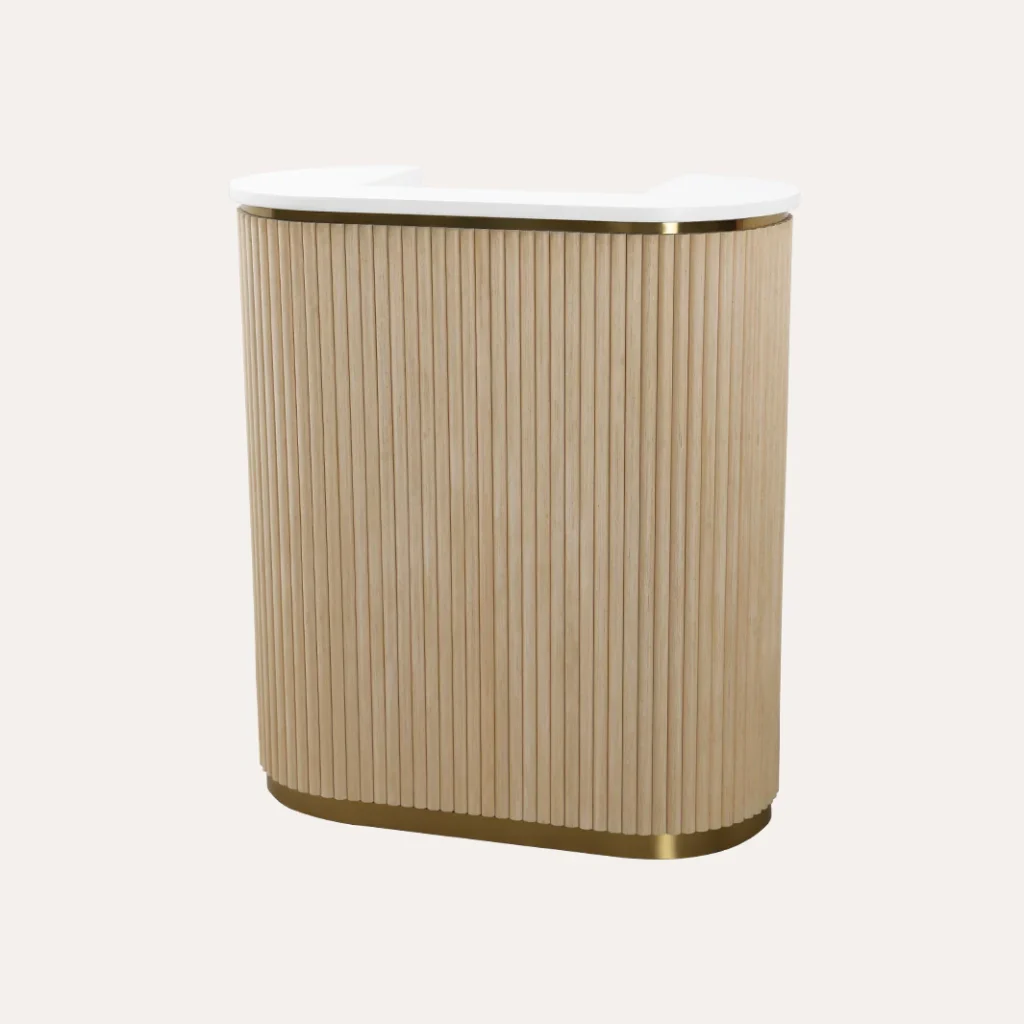 A luxurious salon reception area with a sleek, modern design. In the foreground, a marble-topped reception desk with a stylish James Barber Shop logo prominently displayed. Behind the desk, plush leather chairs and a minimalist coffee table create a cozy waiting area. The middle ground features a striking geometric light fixture that casts a warm glow, while tall windows in the background flood the space with natural light. The overall atmosphere is one of sophistication and relaxation, inviting clients to unwind before their hair treatments.